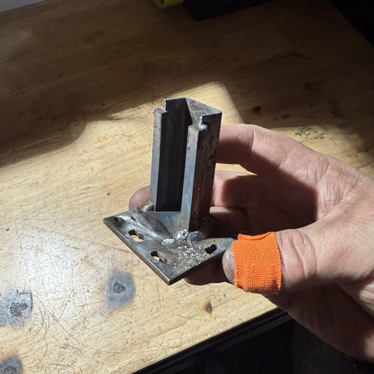 Close view of a small welded steel bracket