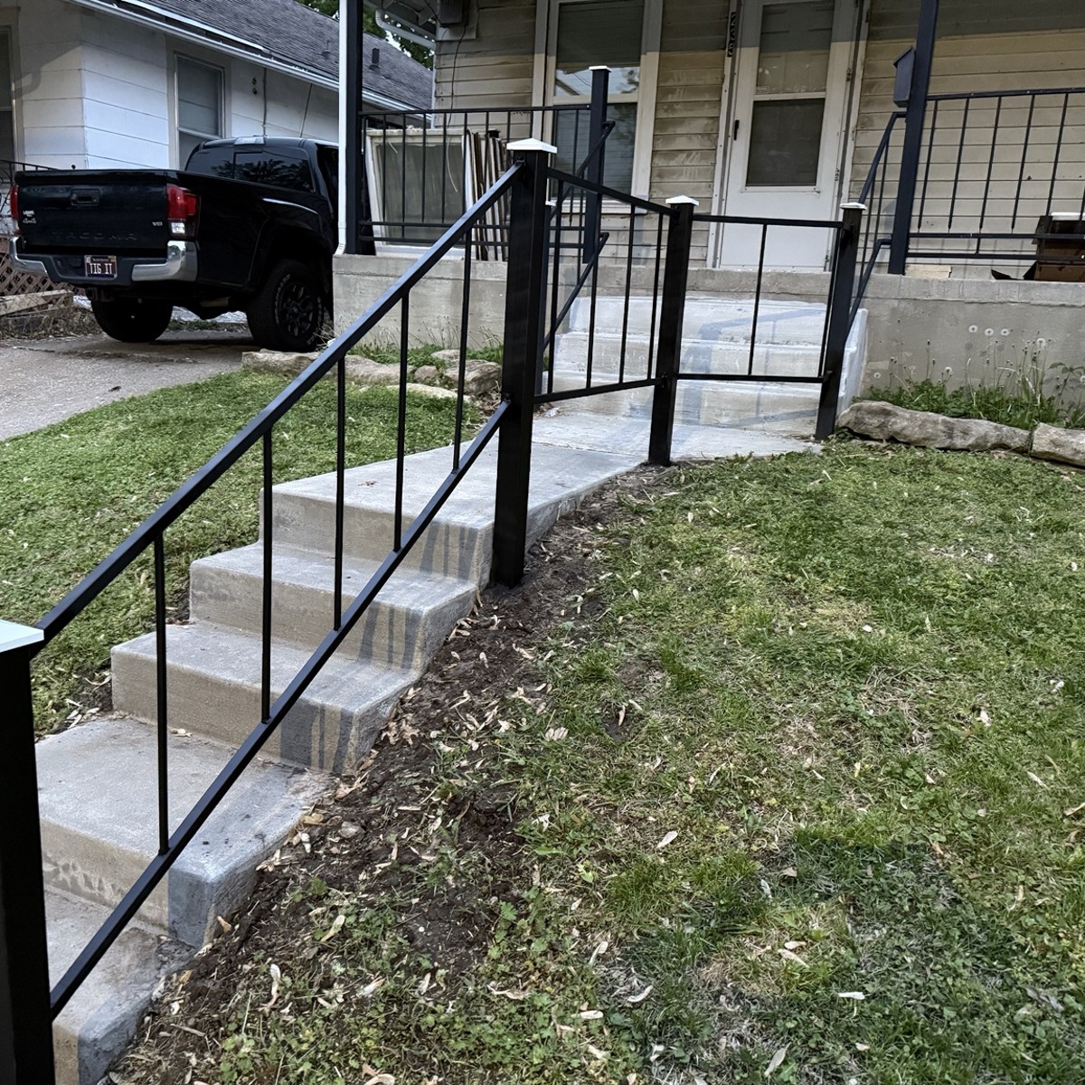Front view of black steel stair railings at a home