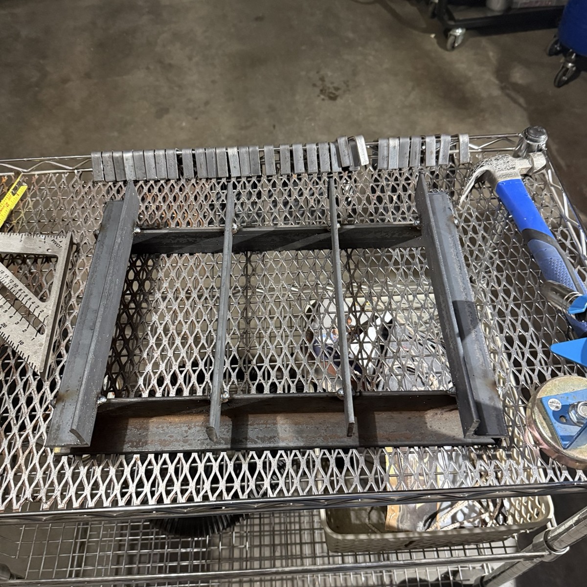 Metal fixture parts laid out on a shop cart