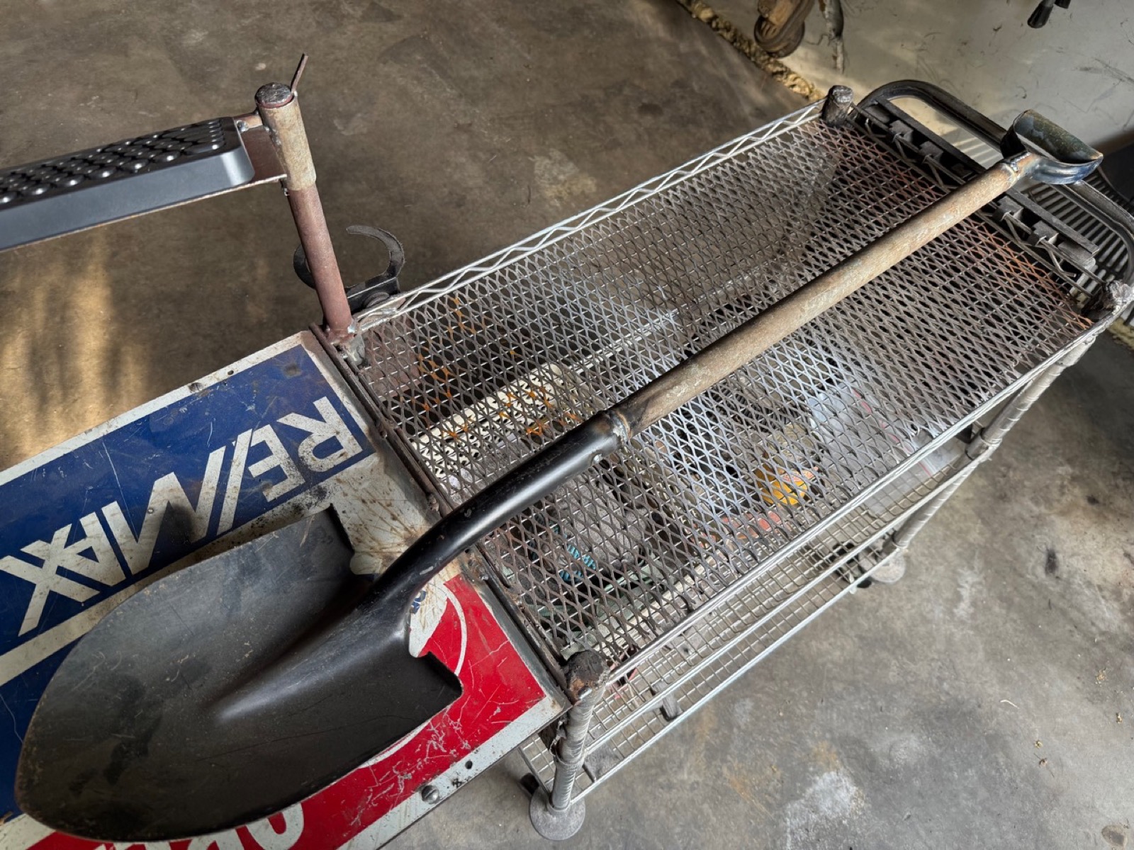 Welded shovel and tool rack mounted on a mesh shop cart