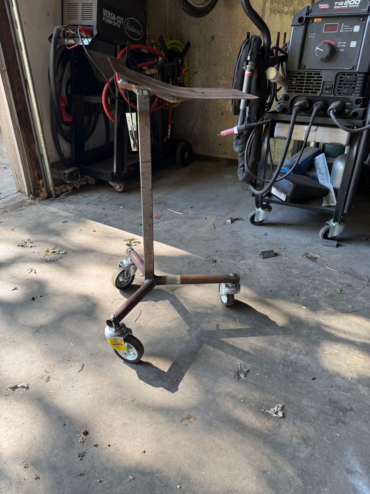 Side view of a welded rolling steel stand beside welding equipment