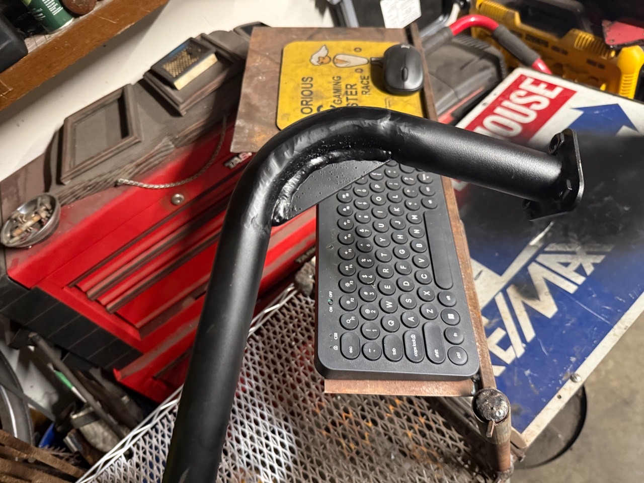 Close view of the curved reinforcement and mounting plate on a welded steel handle